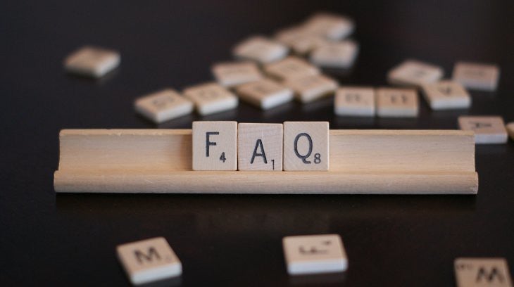 Wooden blocks that say "FAQ" with more in the background