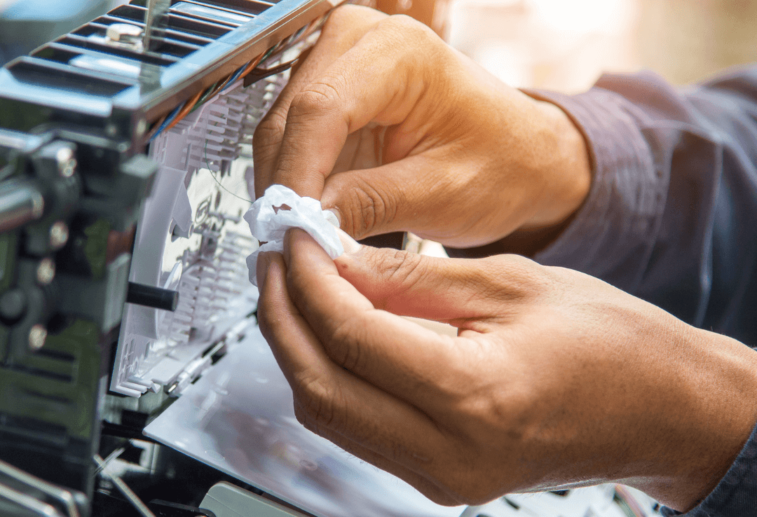 Technician cleaning fiber optic cables, ensuring optimal connectivity.