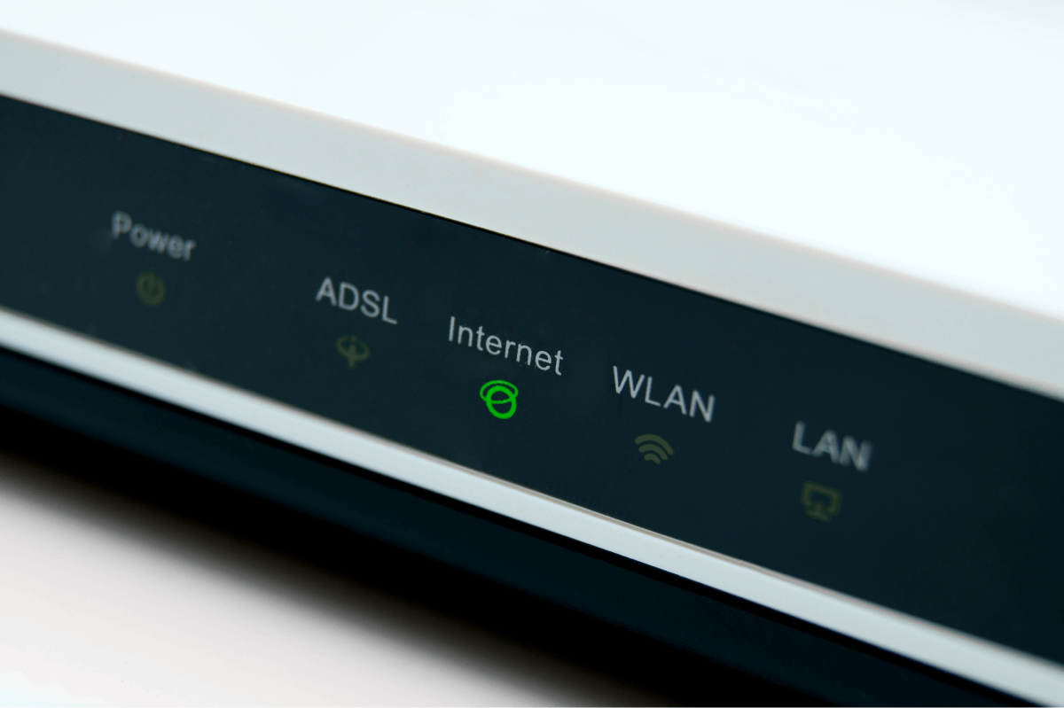 White modem with green light for wifi network and internet connection