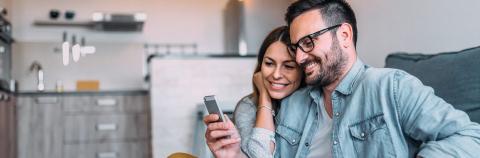 Couple on couch enjoying internet.
